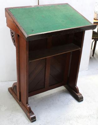 An early-to-mid 20th century stained pine lectern, chevron front to curved, carved bracket supports, 106 x 66cm.