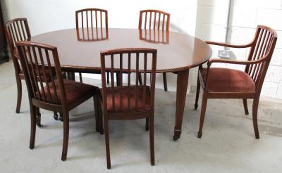 Waring & Gillows; an Edwardian mahogany wind-out table with single and half-leaf, on boxwood inlaid base with square tapering legs to spade feet, supported on porcelain castors, 122 x 180cm when extended and a matching set of six dining chairs (five and a carver) (7).