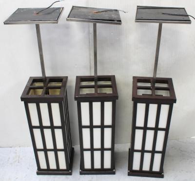 A matched group of three pendant lantern ceiling lights in the Proto-Modernist style, suspended on square section brushed steel rods, height of each 100.5cm (3).