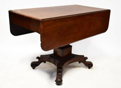 A Victorian mahogany Pembroke table with single frieze drawer, raised on square section column to quadripartite base with scrolling feet to castors, 73 x 103 x 57cm, leaf 28cm.