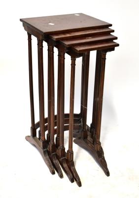 A reproduction nest of four tables raised on reeded supports, largest 71 x 35 x 26cm (af).