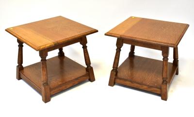 A matched pair of modern square top oak coffee/occasional tables, the square tops with shaped edge, on a tapered frame of turned columns and lower shelf, 46 x 53 x 53cm (2).