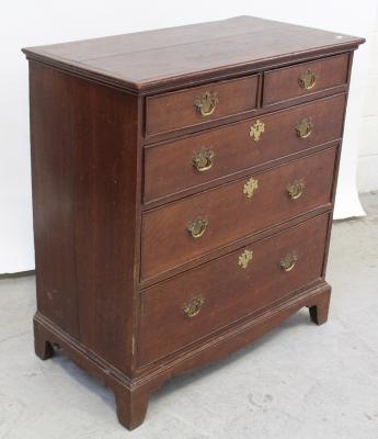 A George III rectangular oak chest of two-over-three graduated drawers, with later solid back plate handles and escutcheons, on a bracketed plinth base, height 99cm.