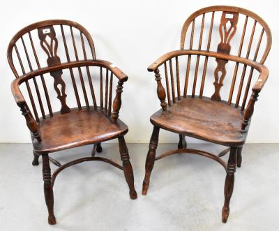 A near pair of Georgian ash and elm open-arm Windsor chairs, raised on ring turned supports united by a crinoline stretcher (2).