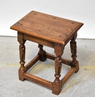 An oak joint stool with rectangular top, on bulbous carved and turned supports united by stretchers, 47 x 44 x 28cm.