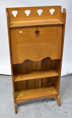 An early 20th century oak students' bureau, the three-quarter galleried top with pierced decoration above fall front, fitted interior, above two open shelves and raised on bracket feet, 126 x 61 x 25cm.