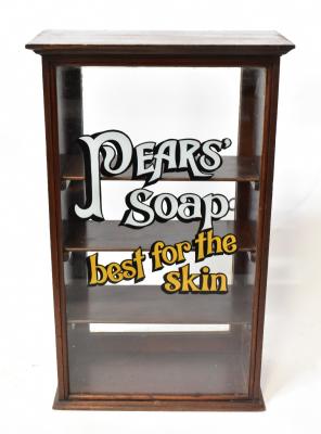 A pine mahogany stained glazed display cabinet with 'Pear's Soap' logo, with three interior shelves, 70 x 44 x 21cm, an Edwardian Neo-Egyptian style mahogany stool with outswept arms, to turned column supports, upholstered in multicoloured Cubist-style fabric and a pair of Art Deco style decorative prints, each 30 x 30cm, framed and glazed (4).