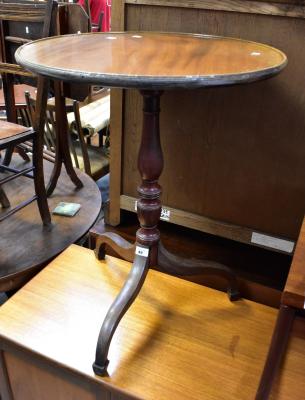 A mahogany circular dished topped occasional table raised on turned column to three outswept scrolling supports, 71 x 56cm.