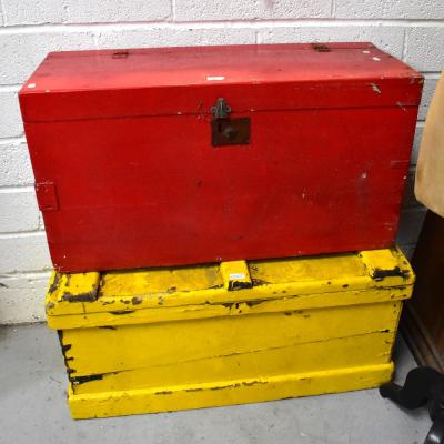Two 19th century wooden travel chests, one painted red, the other sunshine yellow, both with metal carrying handles, the largest 45 x 95 x 44cm (2).
