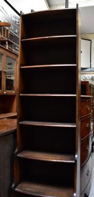 Three pieces of mid-century mahogany furniture comprising a tall slender bookcase, 175 x 48 x 25cm, a small bookcase, height 80cm, and a single-door cabinet/standard lamp, height 163cm (3).