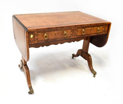 A late 19th/early 20th century walnut sofa table with double ebony inset border to the top, the dome drop flap ends supported by pull-out brackets, over two drawers, brass drop handles and ebony inset trim, raised on two square pillars united by a shaped stretcher, with two cabriole legs, brass end caps and castors, 73 x 157 (extended) x 61cm.  Provenance: From the descendants of Andrew Barclay Walker (of Walker Gallery Liverpool), this item has been passed down the generations and is suggested 