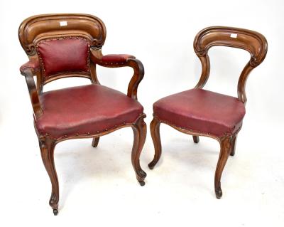 A set of ten Victorian mahogany balloon back chairs with red leatherette upholstered stuff-over seats, raised on carved cabriole front supports to castors (af) (8+2).