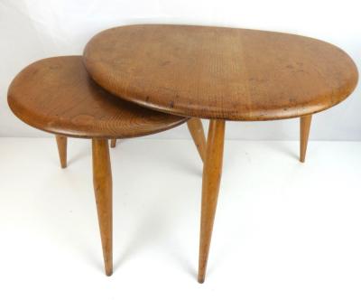 ERCOL; two vintage pebble-style coffee tables with three tapered turned legs, height of largest 36cm, width 49cm (2).