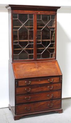 A George III mahogany bureau bookcase, the astragal glazed elevated bookcase section with adjustable shelves surmounts a fitted bureau cabinet with four graduated drawers on shaped plinth base, height approx 203.5cm.