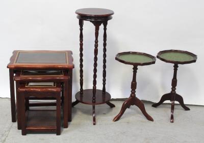 A nest of three contemporary mahogany brass inlaid tables with glass tops, a pair of reproduction mahogany green faux leather topped wine tables on column support to tripartite base and a contemporary mahogany Edwardian-style jardinière stand on wrythen supports to lower shelf (4).