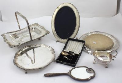 A good collection of silver and plated ware to include an 800 grade silver picture frame of oval form, a silver and engine-turned enamel dressing table mirror, a George V hallmarked silver Christening set to include spoon and shove in black Moroccan leather case, an EPNS mounted beech chopping board, a plated sauce boat and a plated card salver (7).