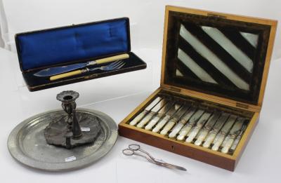 A cased set of abalone-handled flatware, a Tudric pewter charger, an Old Sheffield Plate chamber stick, a set of grape scissors and maroon Moroccan leather cased fish servers (5).