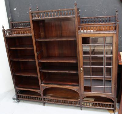 A good late 19th century Aesthetics period rosewood triple bookcase, the galleried top with finials surmounts three glazed bevelled glass doors over an open shaped lower gallery, height 174cm.