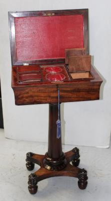 A William IV mahogany four-compartment teapoy, the lid opening to reveal four tea canisters and apertures for sugar bowls, supported on plain column to lappet-carved quadripartite platform base, height 76cm.