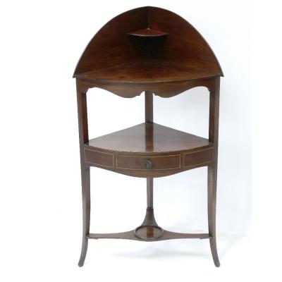 A 19th century mahogany corner washstand, the central section with frieze drawer, supported on swept square tapering legs united by a shelf stretcher, height 103.5cm.