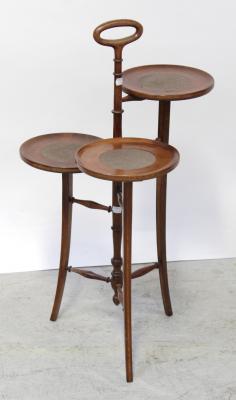 An early/mid-20th century mahogany inlaid three-tier cake/sandwich stand, turned central column and carrying handle to splayed tapering supports, metal name plate to base 'P.E. Gane Late Trapnell & Gane Ltd', height 82cm.