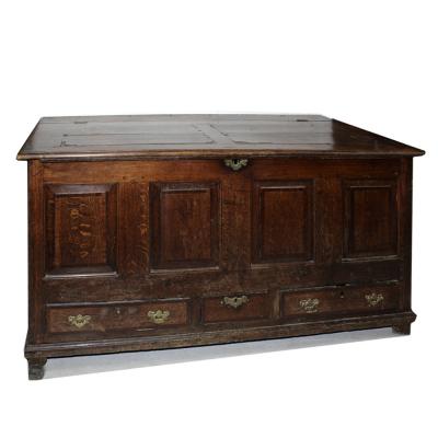 A mid-18th century oak four-panel mule chest, the lid with oak panels cross-banded in mahogany and with two long and one narrow lower frieze drawers, width approx 151cm.