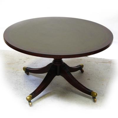 A 20th century mahogany reproduction tilt-top table on quadripartite pedestal base to brass slipper castors, height 50cm.