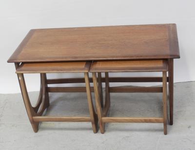 A nest of three mid-20th century teak G-Plan tables comprising one large coffee table, width 99cm and two smaller tables.