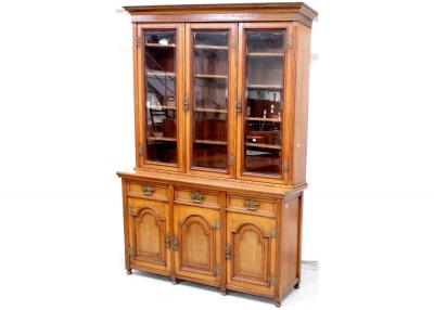 A late Victorian oak triple-front elevated bookcase, the glazed upper section with adjustable shelves surmounting three frieze drawers and three arched panel doors, height approx 235cm.