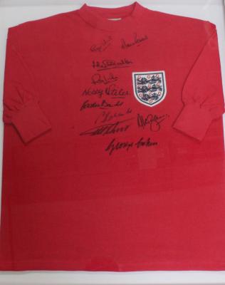 A 1966 England World Cup replica football shirt with ten signatures from the original 1966 squad including Nobby Stiles, Gordon Banks, Ray Wilson, Jack Charlton, Alan Ball, Roger Hunt, Bobby Charlton, Geoff Hurst, etc, with certificate of authenticity.