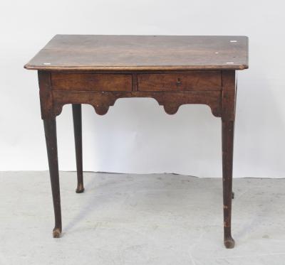 An 18th century mahogany lowboy, two small drawers over curved frieze to turned tapering supports and pad feet, length 83cm.