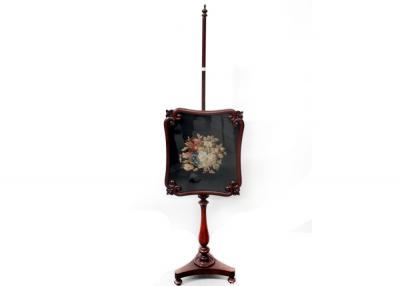 A 19th century mahogany pole screen with floral tapestry inlay to turned column support and tripartite base to bun feet, height 155cm.