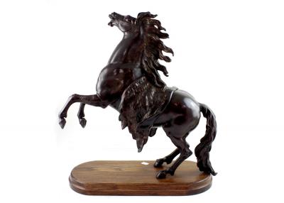 A late 19th/early 20th century bronze Marly horse after Guillaume Coustou the elder, on a raised rectangular base, height 53cm.