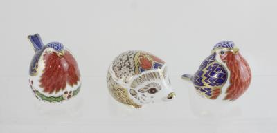 Three boxed Crown Derby paperweights, 'Christmas Robin', a large 'Hedgehog Hawthorn' and a robin, all with gold stoppers (3).