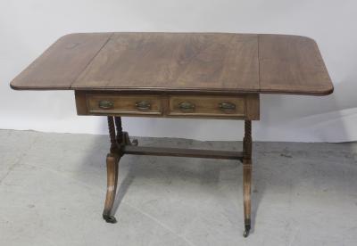 A George III mahogany and rosewood cross-banded sofa table on twin-pillar base with sabre legs to brass slipper castors, width 77.5cm.