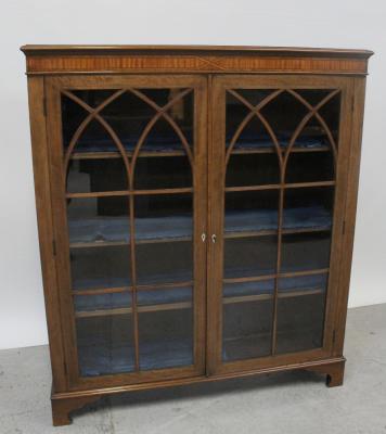 An Edward VII mahogany and satinwood banded bookcase, the glass panel doors with arched line inlaid glazing bars enclosing adjustable shelves, all supported on square bracket feet, height 140cm.