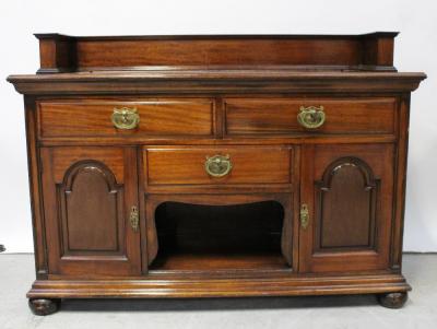 A 19th century mahogany buffet/sideboard, stepped frieze to the back over two drawers to central pot cupboard with an arched panel door to either side, to plinth base and bun feet, 110 x 150cm.