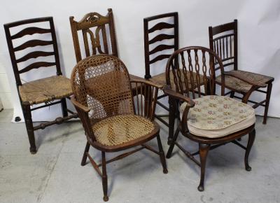 A Victorian oak hall chair, carved openwork back to turned supports, two ladder-back Lancashire chairs with rush seats, one other 19th century kitchen chair with spindle back and rush seat and two non-matching bergère chairs, one with bergère back and seat and outswept arms, the other with stick back to bergère seat (6).
