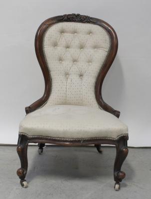 A Victorian walnut spoon-back fireside chair in deep buttoned patterned cream fabric, height 91cm..