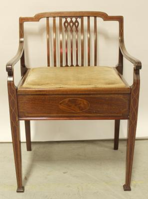 An Edwardian mahogany inlaid piano seat.