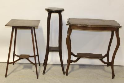 An Edwardian mahogany shaped side table, a similar jardinière stand and a further jardinière stand (3).