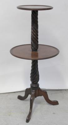 An early 20th century mahogany dumb waiter, central wrythen column with acanthus leaf decoration to tripartite base, height 107cm.