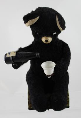 A Japanese c1950s plush and tin plate, battery-operated drinking bear toy, height approx 24cm.