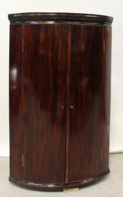 A George III mahogany wall-hanging corner cupboard, length 105cm.