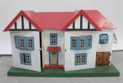 A model c1920s detached dolls' house with a quantity of dolls' house furniture and models to the interior, 42 x 72cm.