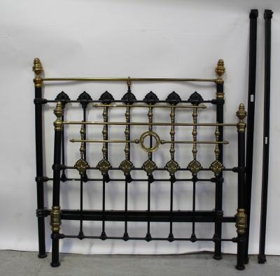 An Edwardian brass black metal double bed frame, urn finials to the top and shell and turned supports to base and foot, width 138cm.
