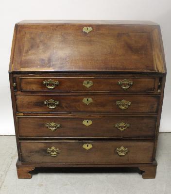 A George III mahogany bureau, the fall-front enclosing fitted interior above four drawers, raised on bracket feet.
