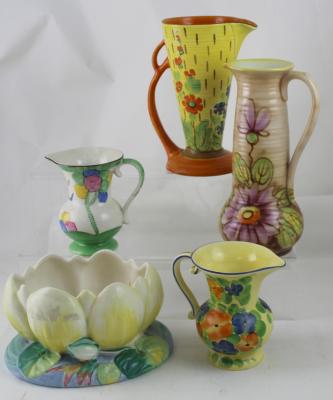 A Clarice Cliff 'Water Lily' bowl, green stamped signature to base, diameter 23cm and four Art Deco pottery jugs (5).