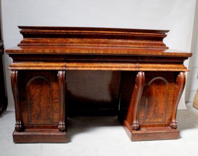 A Victorian flame mahogany twin-pedestal sideboard with shaped back above three cushion drawers and two cupboard doors to plinth base, width 184cm, height 118cm.