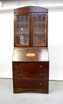 A 1930s bureau bookcase, the top with twin leaded glazed doors, the base with fall front over three long drawers, on bracket feet, height approx 190cm.